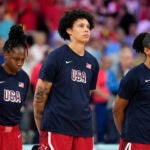 United States' Brittney Griner, center, stands on the court during the national anthem prior to a women's basketball game against Belgium at the 2024 Summer Olympics.