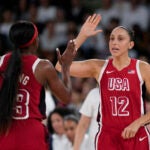 United States' Diana Taurasi (12) celebrates with United States' Jackie Young (13) during a women's quarterfinal game against Nigeria at Bercy Arena at the 2024 Summer Olympics.