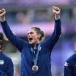 United States' Ilona Maher, centre reacts as she stands on the podium with her bronze medal during the presentation ceremony Rugby Sevens at the 2024 Summer Olympics.