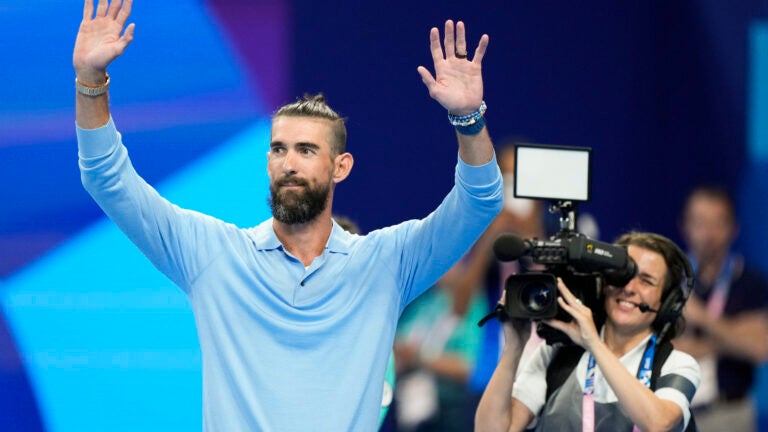 Former Olympic champion Michael Phelps, from the United States, waves to fans ahead of the evening swimming session at the 2024 Summer Olympics.