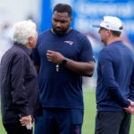 New England Patriots head coach Jerod Mayo, center, talks with team owner Robert Kraft, left, and Eliot Wolf, team executive vice president of player personnel, during an NFL football training camp, Thursday, July 25, 2024, in Foxborough, Mass.