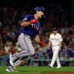 Wyatt Langford of the Texas Rangers celebrates his game-tying, three-run home run against the Red Sox in the ninth inning at Fenway Park.