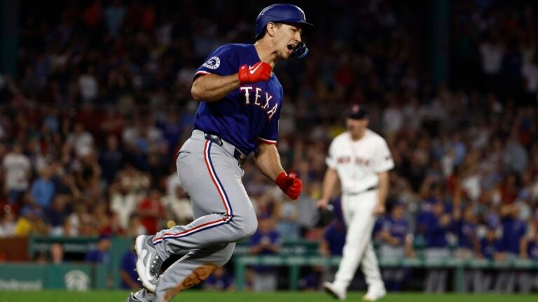 Wyatt Langford of the Texas Rangers celebrates his game-tying, three-run home run against the Red Sox in the ninth inning at Fenway Park.