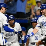 Kansas City's Bobby Witt Jr., left, is congratulated by teammate Vinnie Pasquantino after hitting a solo home run during the sixth inning against the Red Sox.