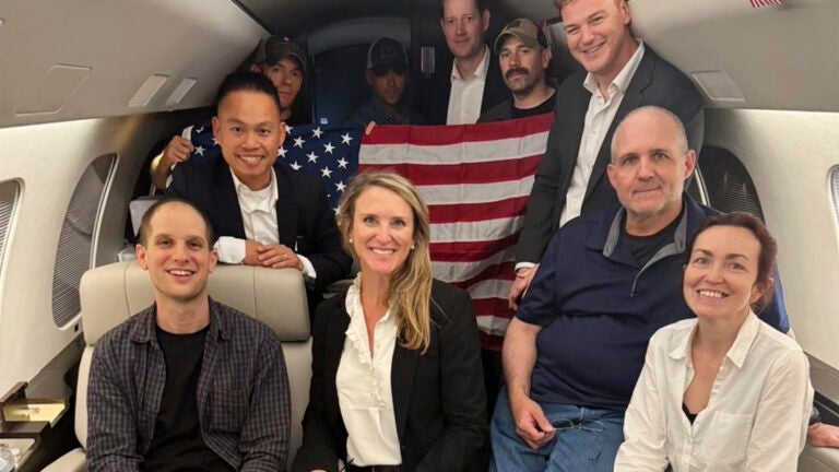 This image released by the White House shows Evan Gershkovich, left, Alsu Kurmasheva, right, and Paul Whelan, second from right, and others aboard a plane, Thursday, Aug. 1, 2024, following their release from Russian captivity.
