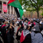 FILE - Graduating students hold Palestinian flags and chant during commencement at Harvard University, Thursday, May 23, 2024.