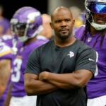Minnesota Vikings defensive coordinator Brian Flores watches his players prior to an NFL preseason football game against the Arizona Cardinals, Aug. 26, 2023, in Minneapolis. Flores still has a pit in his stomach when he thinks about the Khyree Jackson and the car crash that took the rookie cornerbacks' life earlier this month. The Vikings defensive coordinator was not only enamored by Jackson's potential but by the unconventional path he took to the NFL.