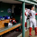 Jarren Duran grabs his hat as he stands in a near empty Red Sox dugout.