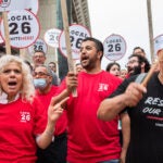 Marta McClung (left), who currently works at Omni Seaport but has worked at hotels around Boston since 2004, and Luis Manuel (right, playing drum), who has worked for 3 years at the Hyatt Place in Seaport rally at a press conference addressing a after a strike authorization vote by UNITE HERE Local 26 in City Hall Plaza on Thursday, August 8, 2024.