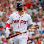 Boston Red Sox Jarren Duran walks off the field after striking out swinging against the Houston Astros during third inning MLB action at Fenway Park.