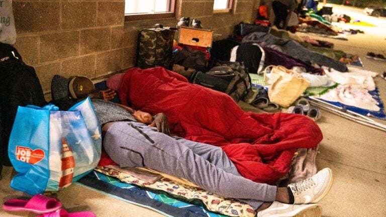 As funds for shelter dry up, migrant families sleep outside the T-Station in Quincy