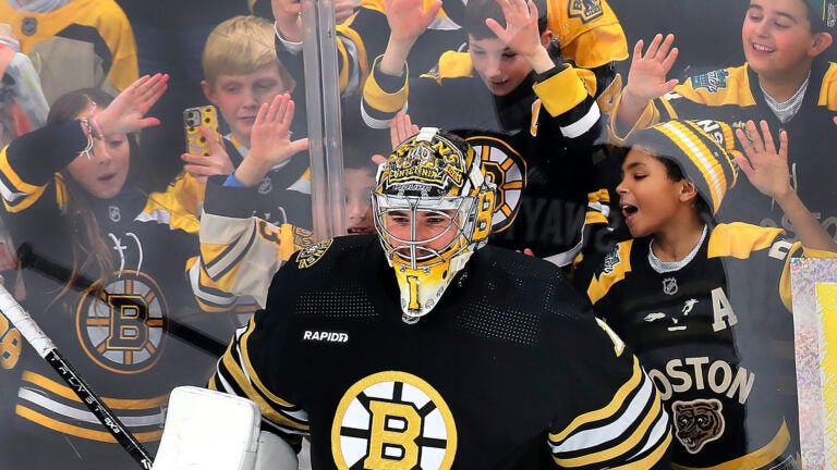 Boston Bruins vs Pittsburgh Penguins- Young fans try to get the attention of Boston Bruins goaltender Jeremy Swayman (1) during pregame warm-ups.