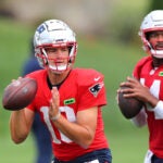 The NE Patriots held training camp at Gillette Stadium. Qb’s Drake Maye(left) and Jacoby Brissett line up to pass during a drill.