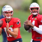 The NE Patriots held training camp at Gillette Stadium. Qb’s Drake Maye(left) and Jacoby Brissett line up to pass during a drill.