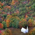 Fall foliage surrounds a small church near East Parsonsfield, Maine.