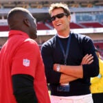 Tom Brady chats with former San Francisco 49er Frank Gore before Niners play New Orleans Saints during NFL preseason game at Levi's Stadium in Santa Clara, Calif., on Sunday, August 18, 2024.