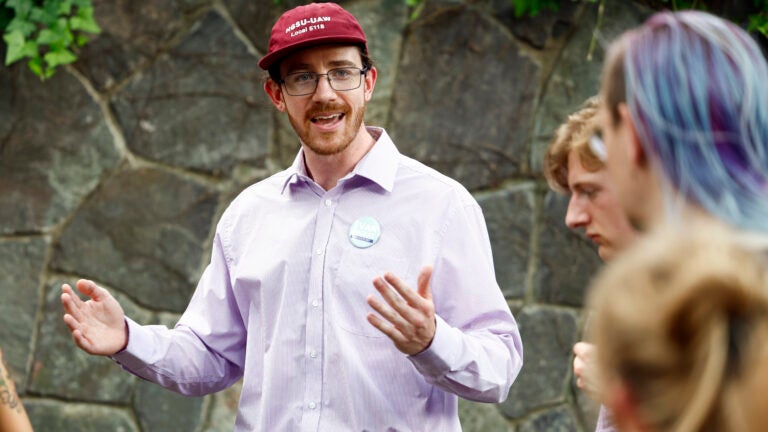 Evan MacKay, a Democratic candidate running for state representative in the 25th Middlesex District, talks to volunteers before canvassing in Cambridge in July.