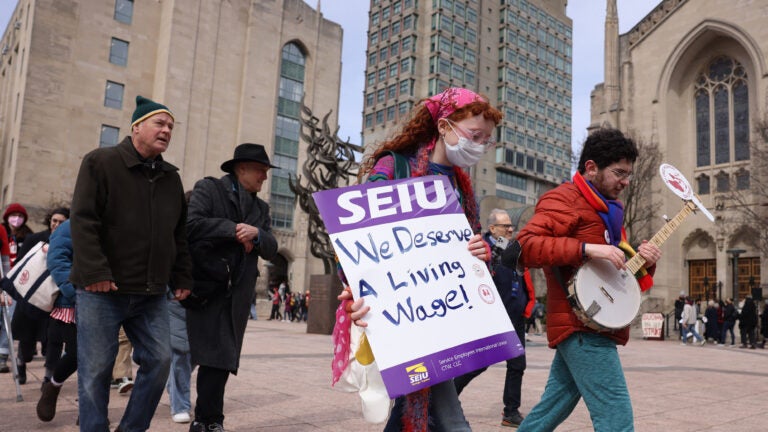 Boston University graduate worker students and supporters walked a picket line outside of BU’s Marsh Chapel in March.