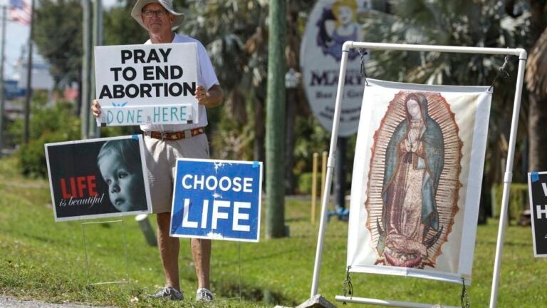 Dave Behrle, 70, of Safety Harbor holds a sign while standing outside the All Women's Health Center of Clearwater on May 3, 2022.