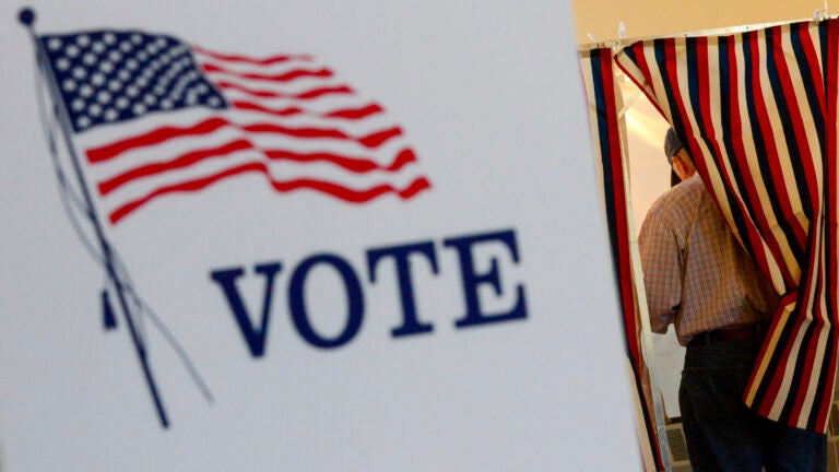 Lyell Williams of Chesterfield, NH, fills out his ballot during the New Hampshire state primary.