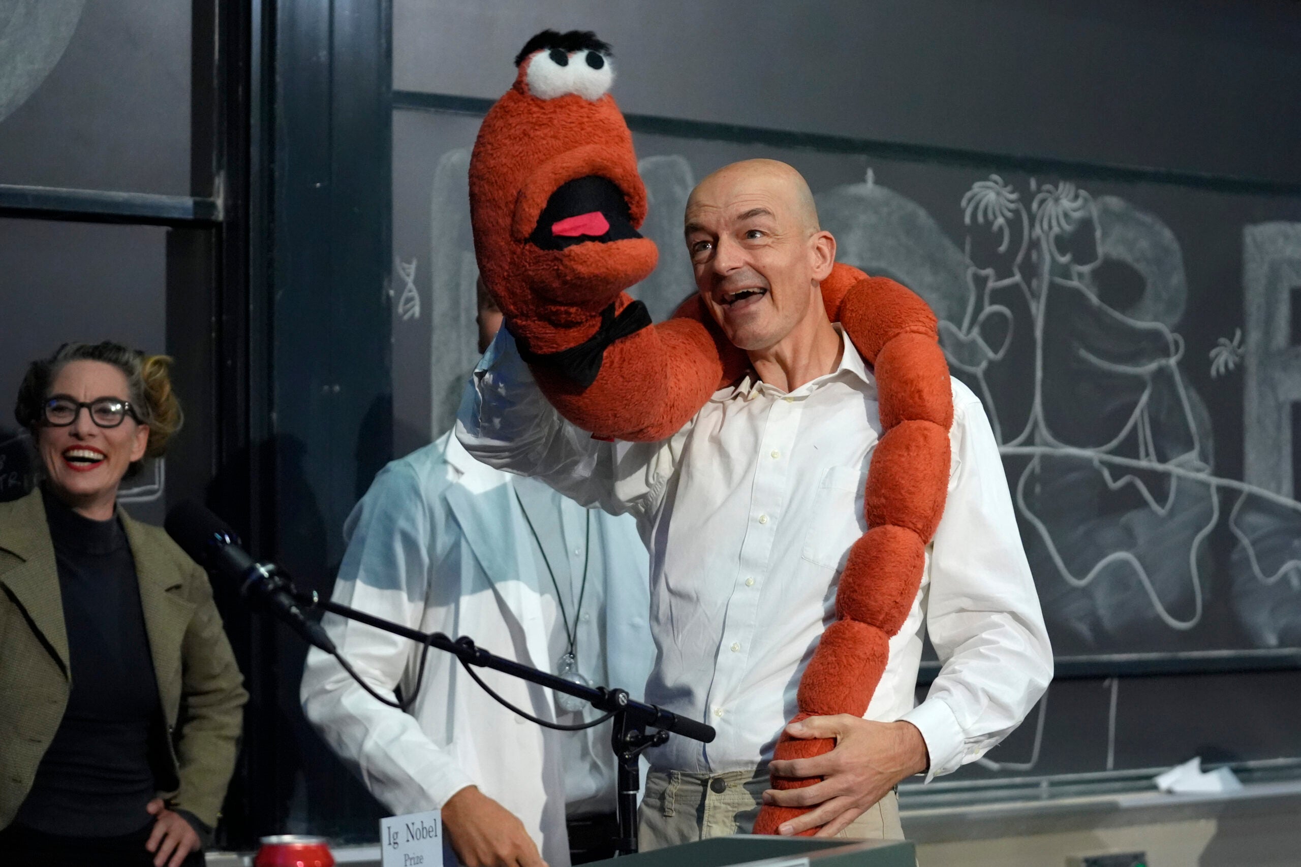 Professor Sander Woutersen, right, shows an oversized stuffed worm. 