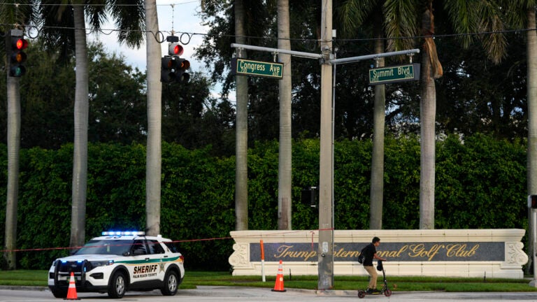 A vehicle with the Palm Beach County Sheriff's office is parked outside of Trump International Golf Club.