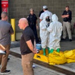 A hazmat crew from the National Guard's Civilian Support Team investigates after a suspicious package was delivered to election officials at the Missouri Secretary of State's Jefferson City, Mo., office.