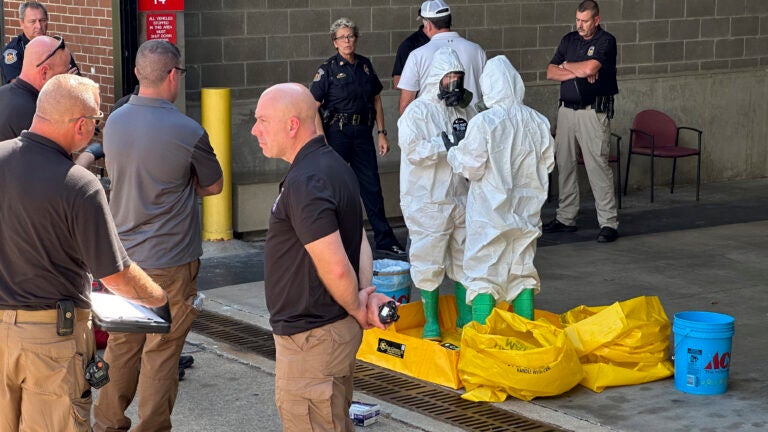 A hazmat crew from the National Guard's Civilian Support Team investigates after a suspicious package was delivered to election officials at the Missouri Secretary of State's Jefferson City, Mo., office.