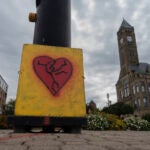 An image of a broken heart is fixed across the street from City Hall with the Heritage Center of Clark County.