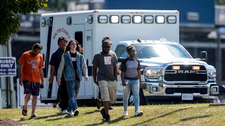 Students and parents walk off campus at Apalachee High School, Wednesday, Sept. 4, 2024, in Winder, Ga.