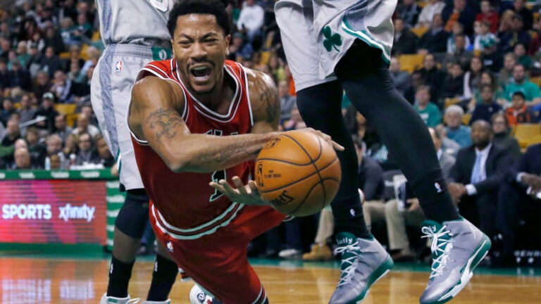 Derrick Rose falls after being tripped while driving against the Celtics, Nov. 28, 2014.