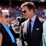 Tom Brady and Cowboys owner Jerry Jones talk with others during team warmups before a game against the Browns.