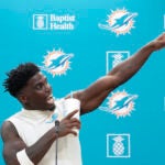 Tyreek Hill gestures during a press conference following a team practice in Miami Gardens.