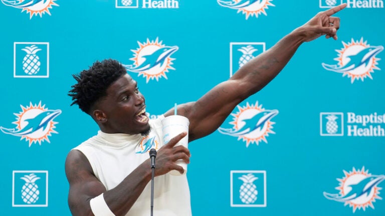 Tyreek Hill gestures during a press conference following the team's practice in Miami Gardens.