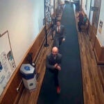 In this image taken from video provided by TMX, Nicholas Carter, 31, attempts to flee the Somerset County Courthouse in handcuffs Wednesday, Sept 11, 2024 in Skowhegan, Maine, after a jury convicted him of aggravated assault against a 14-month-old child. The escape was quickly foiled by two jurors and a detective.