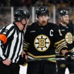 BOSTON, MASSACHUSETTS - MAY 17: Brad Marchand #63 of the Boston Bruins listens to referee Kelly Sutherland #11 during a game against the Florida Panthers during the second period in Game Six of the Second Round of the 2024 Stanley Cup Playoffs at the TD Garden on May 17, 2024 in Boston, Massachusetts. The Panthers won 2-1 to advance to the Eastern Conference final.