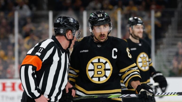 BOSTON, MASSACHUSETTS - MAY 17: Brad Marchand #63 of the Boston Bruins listens to referee Kelly Sutherland #11 during a game against the Florida Panthers during the second period in Game Six of the Second Round of the 2024 Stanley Cup Playoffs at the TD Garden on May 17, 2024 in Boston, Massachusetts. The Panthers won 2-1 to advance to the Eastern Conference final.