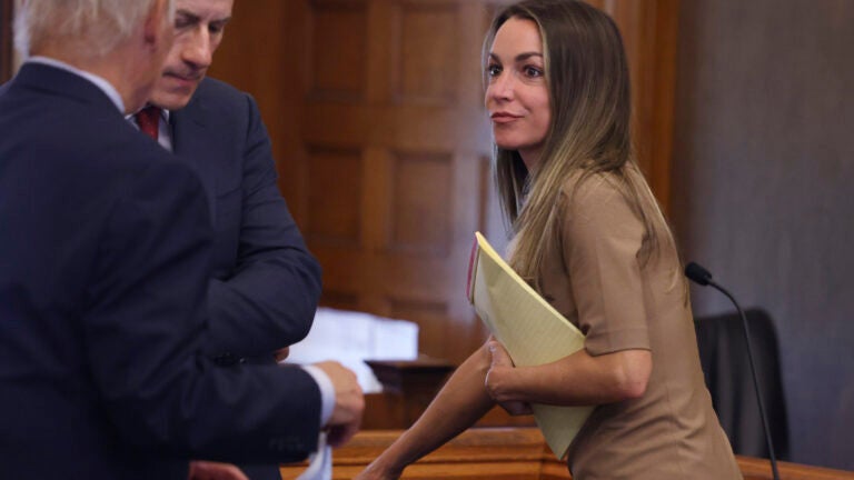 Karen Read, right, talks with her lawyers following a hearing at Norfolk Superior Court, Monday July 22, 2024, in Dedham, Mass.