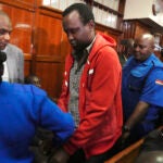 FILE - Kevin Adam Kinyanjui Kangethe is escorted out of the courtroom at the Milimani law court in Nairobi, Kenya, on Feb. 14, 2024.