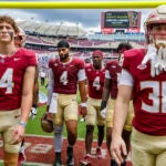 Florida State players walk off the field after losing to Memphis 20-12 in a college football game.