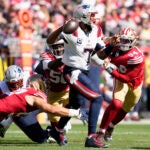 New England Patriots quarterback Jacoby Brissett (7) looks to pass while pressured by San Francisco 49ers defensive end Nick Bosa, bottom, defensive end Leonard Floyd, middle left, and defensive end Yetur Gross-Matos (94) during the second half of an NFL football game in Santa Clara, Calif., Sunday, Sept. 29, 2024.