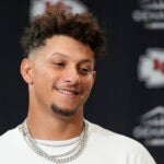 Patrick Mahomes smiles during a news conference after a game against the Ravens.