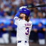 Mets' Jesse Winker follows through on a grand slam against the Red Sox in New York.