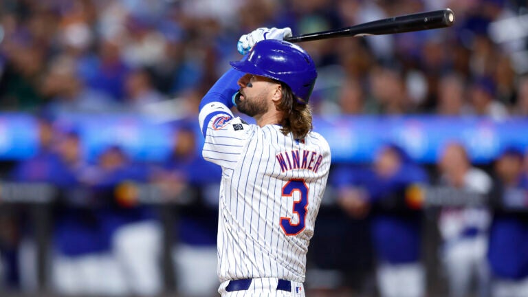 Mets' Jesse Winker follows through on a grand slam against the Red Sox in New York.