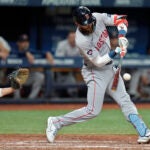 Trevor Story of the Red Sox singles off Tampa Bay relief pitcher Drew Rasmussen during the eighth inning.