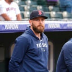 Shortstop Trevor Story looks on before the Colorado Rockies host the Red Sox in a baseball game in Denver.