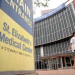 A passer-by walks past an entrance to St. Elizabeth's Medical Center, Thursday, Sept. 19, 2024, in the Brighton neighborhood of Boston.