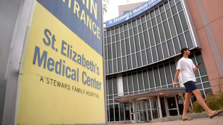 A passer-by walks past an entrance to St. Elizabeth's Medical Center, Thursday, Sept. 19, 2024, in the Brighton neighborhood of Boston.