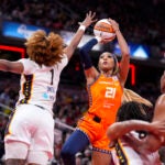 DiJonai Carrington shoots over Indiana Fever's NaLyssa Smith in a game in Indianapolis, Aug. 28, 2024.