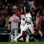 Tyler O'Neill of the Red Sox celebrates his game winning three-run home run during the 10th inning.